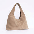 A taupe suede hobo shoulder bag with a single integrated strap.